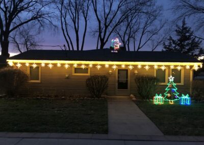 residential holiday lighting with yard art