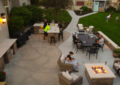 concrete patio, fire pit, and landscaping | after