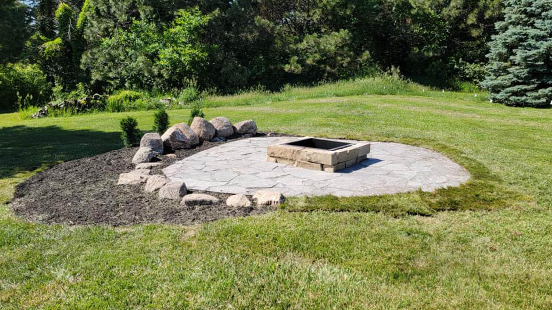 flagstone patio with fire pit and landscaping