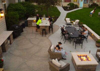concrete patio with landscaping and hardscaping and fire pit