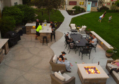 concrete patio with fire pit and retaining walls
