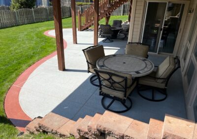 concrete patio in backyard with dining set