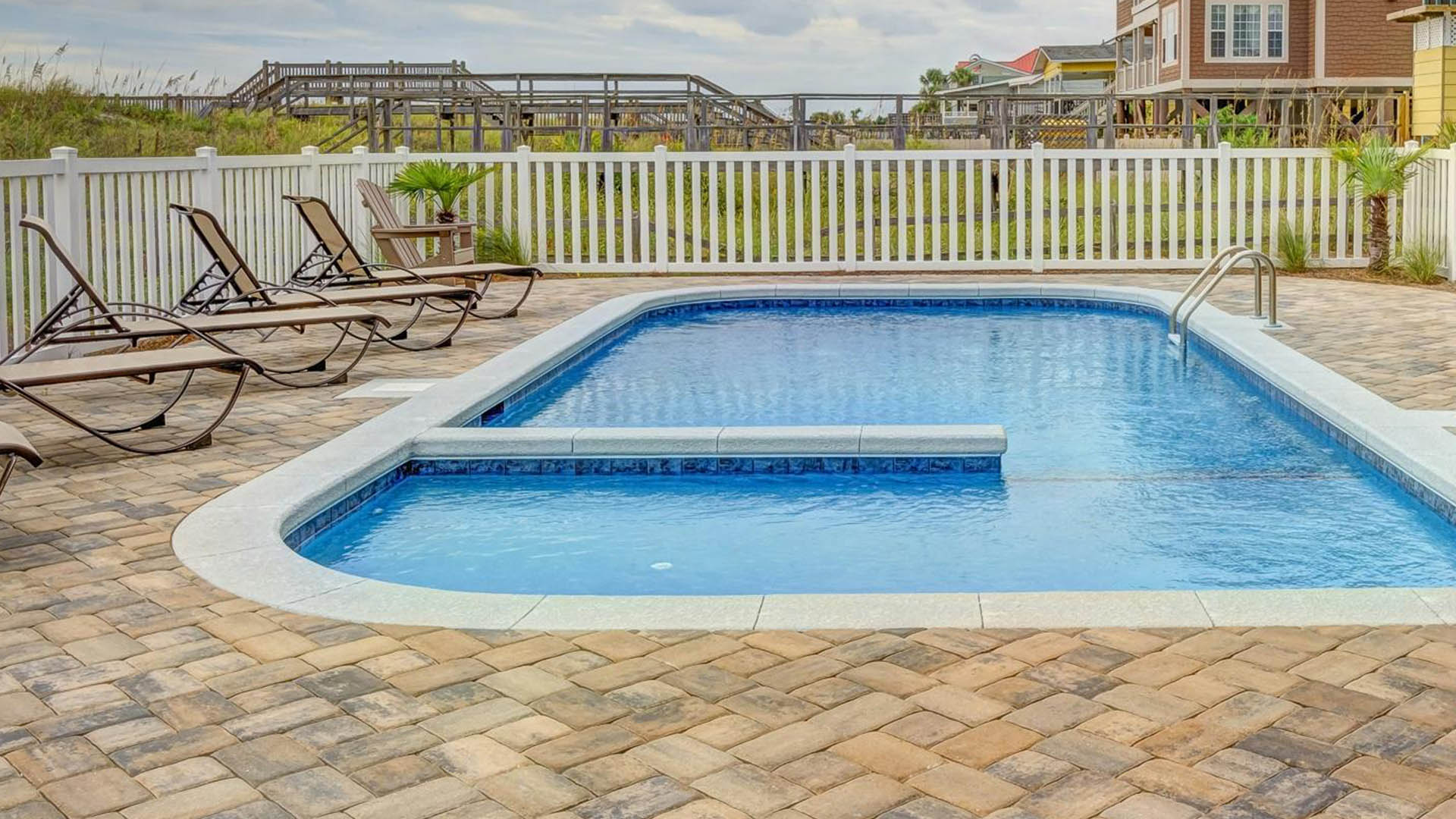 swimming pool with paver stone patio