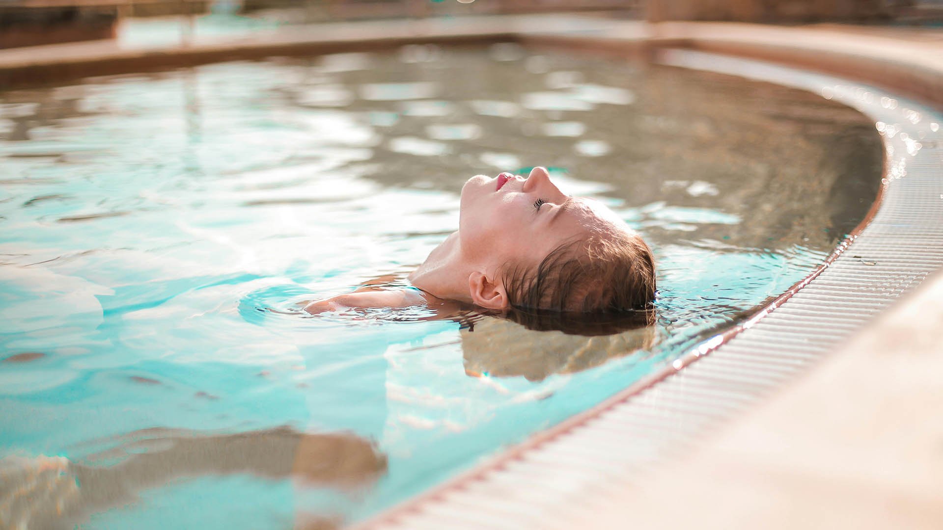 woman floating in calm swimming pool